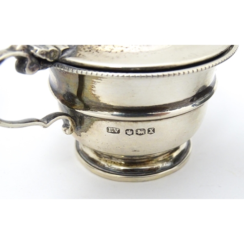 335 - A silver mustard pot hallmarked Birmingham 1926, maker Mappin & Webb Ltd. Together with another hall... 