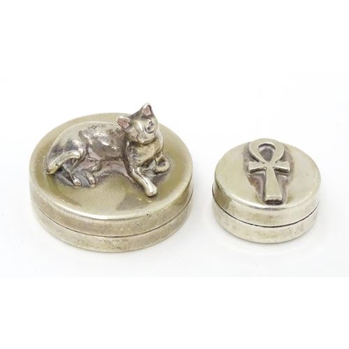 337 - Two Continental silver pill boxes, one surmounted by a model of a cat, bearing silver marks for Iraq... 