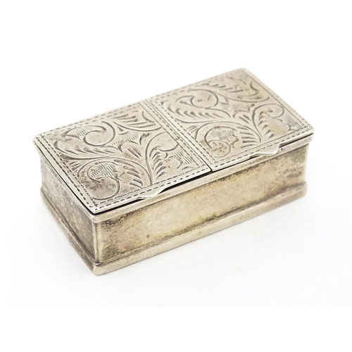 346 - A silver two sectional pill box with engraved acanthus scroll decoration, bearing import marks. Lond... 