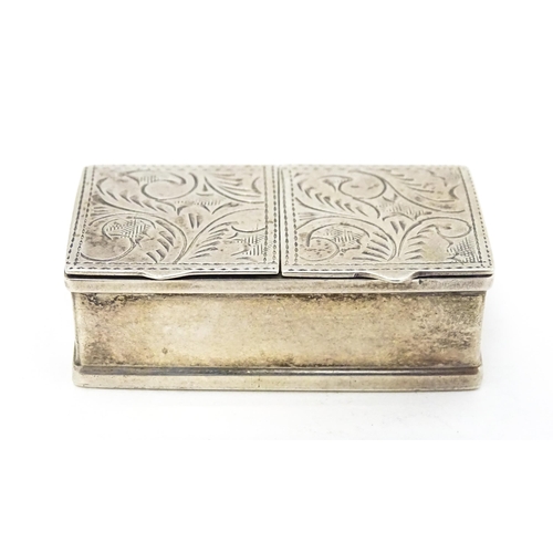 346 - A silver two sectional pill box with engraved acanthus scroll decoration, bearing import marks. Lond... 