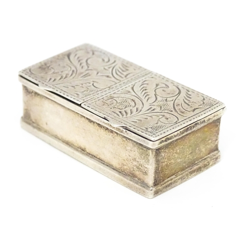 346 - A silver two sectional pill box with engraved acanthus scroll decoration, bearing import marks. Lond... 