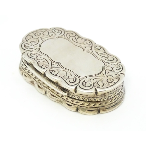 353 - A silver pill box with engraved decoration hallmarked Birmingham 1920, maker George Randle. Approx. ... 