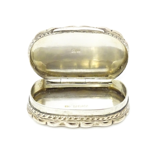 353 - A silver pill box with engraved decoration hallmarked Birmingham 1920, maker George Randle. Approx. ... 