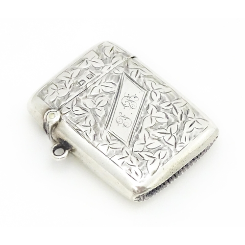 355 - A silver vesta case with engraved foliate decoration hallmarked Birmingham 1911, maker Smith & Bartl... 