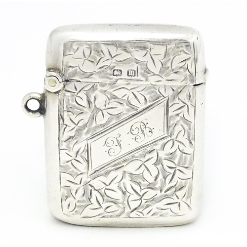 355 - A silver vesta case with engraved foliate decoration hallmarked Birmingham 1911, maker Smith & Bartl... 