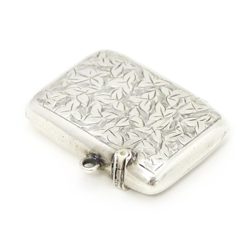 355 - A silver vesta case with engraved foliate decoration hallmarked Birmingham 1911, maker Smith & Bartl... 