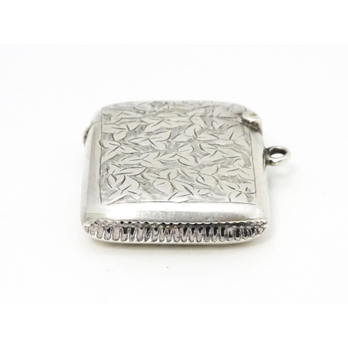 355 - A silver vesta case with engraved foliate decoration hallmarked Birmingham 1911, maker Smith & Bartl... 