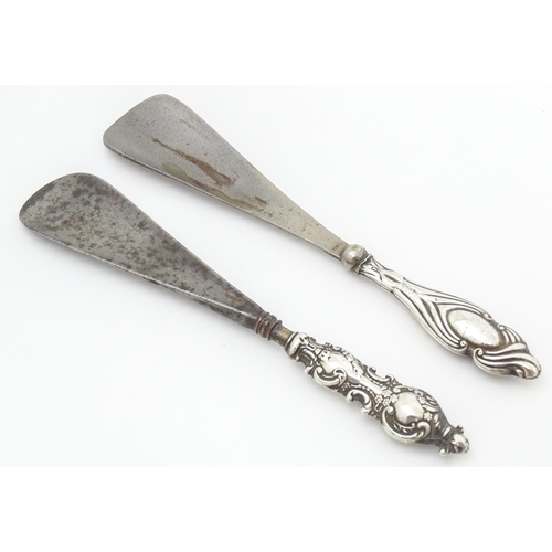 371 - Two silver handled shoe horns, one hallmarked Birmingham 1899 the other Chester 1920.   The longest ... 