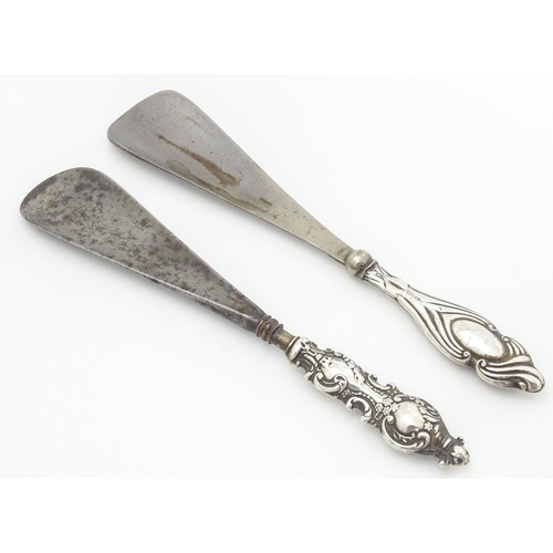 371 - Two silver handled shoe horns, one hallmarked Birmingham 1899 the other Chester 1920.   The longest ... 