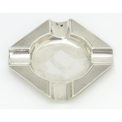 376 - A silver ash tray with engine turned decoration hallmarked Birmingham 1960, maker Adie Brothers. App... 