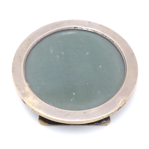 381 - A photograph frame of circular form with silver surround, hallmarked Birmingham 1910. 4 1/2