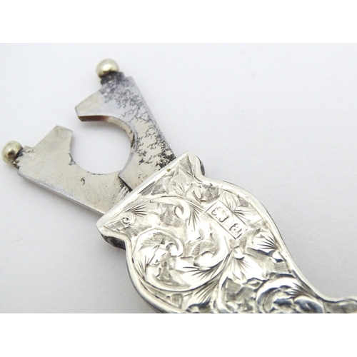 384 - A silver cigar / cheroot cutter of stylised lyre form  with engraved acanthus scroll detail hallmark... 