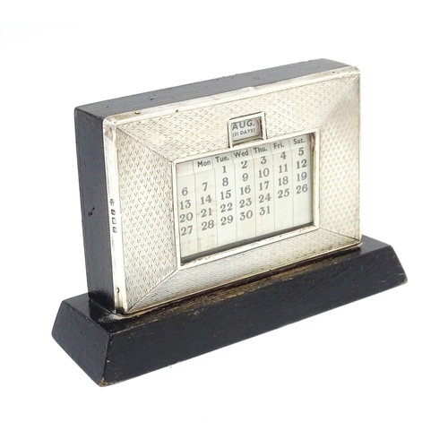 387 - A desk calendar with silver surround hallmarked Birmingham 1938, maker W. J. Myatt & Co. Approx. 4 1... 