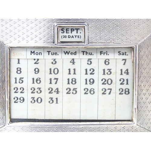 387 - A desk calendar with silver surround hallmarked Birmingham 1938, maker W. J. Myatt & Co. Approx. 4 1... 