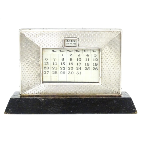 387 - A desk calendar with silver surround hallmarked Birmingham 1938, maker W. J. Myatt & Co. Approx. 4 1... 