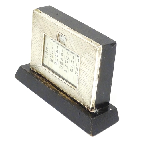 387 - A desk calendar with silver surround hallmarked Birmingham 1938, maker W. J. Myatt & Co. Approx. 4 1... 