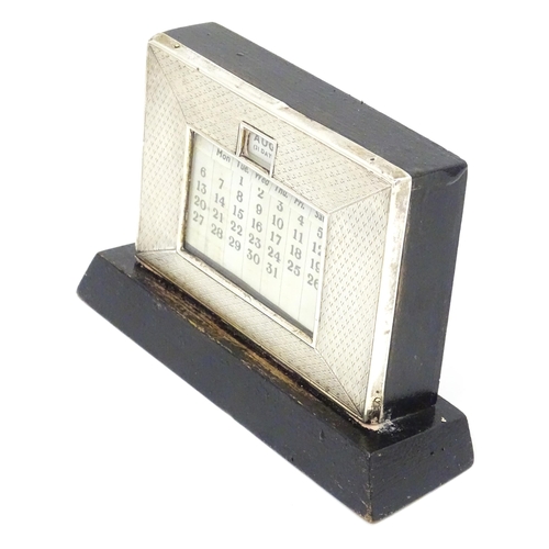 387 - A desk calendar with silver surround hallmarked Birmingham 1938, maker W. J. Myatt & Co. Approx. 4 1... 