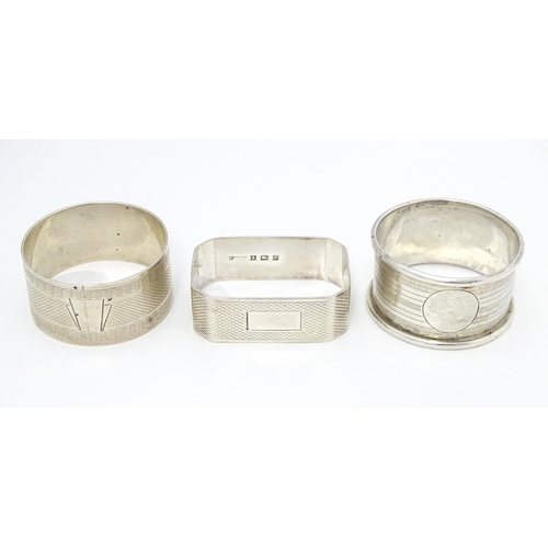 389 - Three assorted napkin rings with engine turned decoration. Hallmarked London 1940, Birmingham 1922 a... 