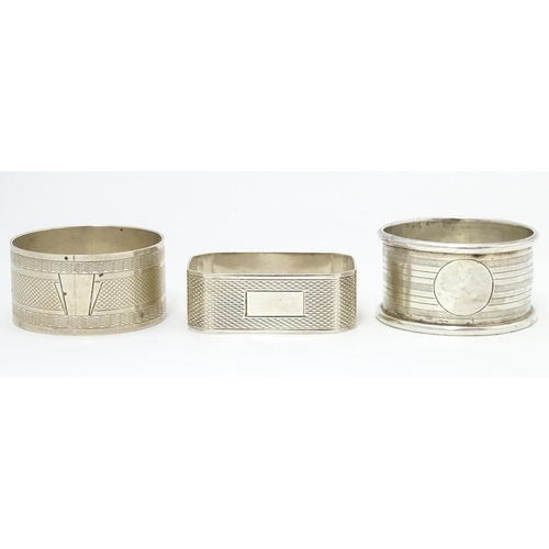 389 - Three assorted napkin rings with engine turned decoration. Hallmarked London 1940, Birmingham 1922 a... 