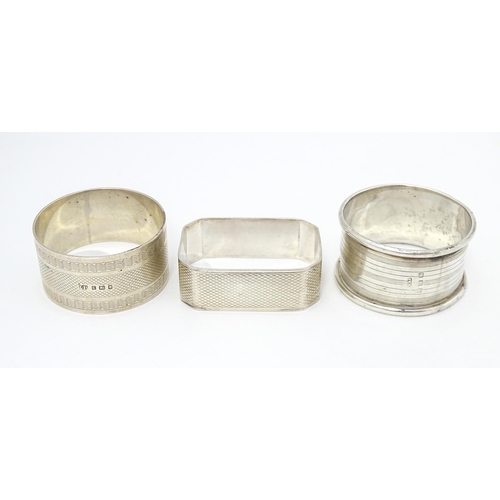 389 - Three assorted napkin rings with engine turned decoration. Hallmarked London 1940, Birmingham 1922 a... 