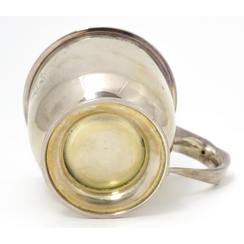 390 - A silver Christening mug with gilded interior. Hallmarked Birmingham 1915 maker Levi & Salaman 2 3/4... 