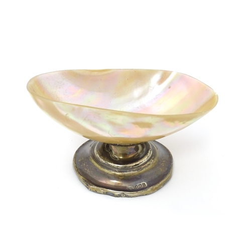 394 - A silver pedestal table salt with mother of pearl shell formed bowl Hallmarked Birmingham 1907 maker... 