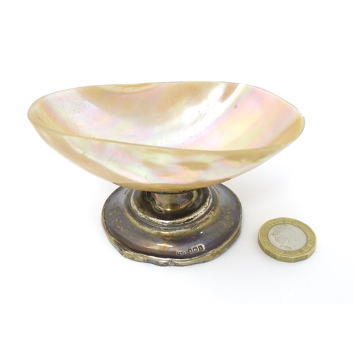 394 - A silver pedestal table salt with mother of pearl shell formed bowl Hallmarked Birmingham 1907 maker... 