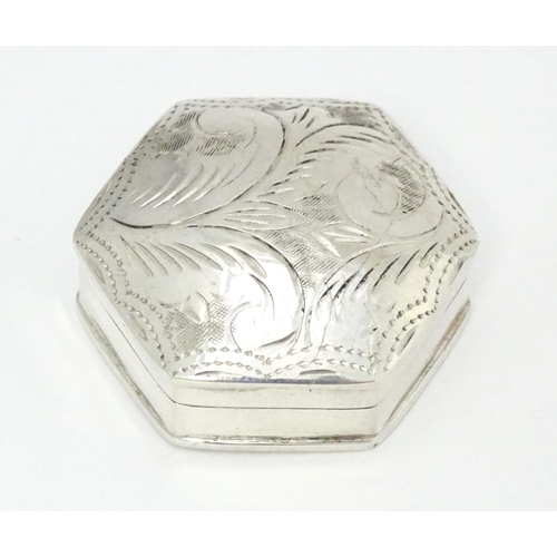 411 - A .925 silver pill box of hexagonal form with engraved decoration. Approx. 1 1/4