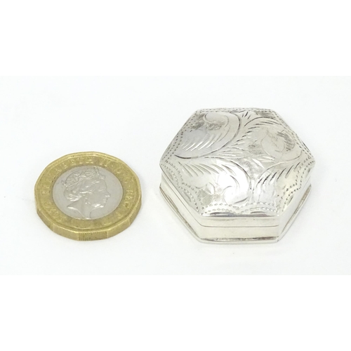 411 - A .925 silver pill box of hexagonal form with engraved decoration. Approx. 1 1/4