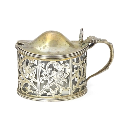 427 - A Victorian silver mustard pot with foliate and bird detail. Hallmarked London 1898. Approx 2 3/4