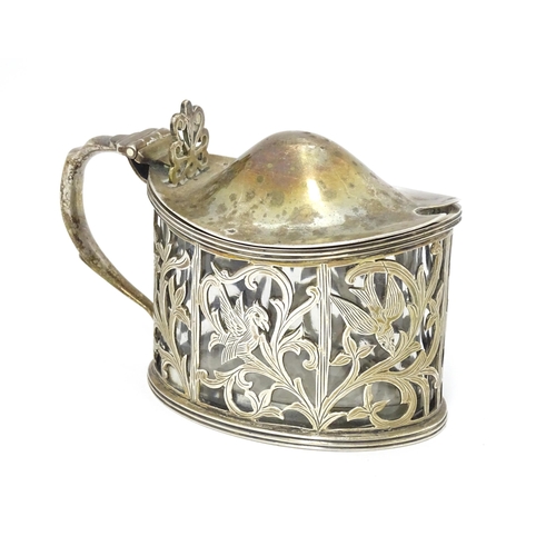 427 - A Victorian silver mustard pot with foliate and bird detail. Hallmarked London 1898. Approx 2 3/4