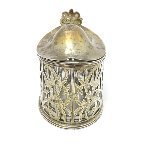 427 - A Victorian silver mustard pot with foliate and bird detail. Hallmarked London 1898. Approx 2 3/4