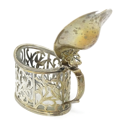 427 - A Victorian silver mustard pot with foliate and bird detail. Hallmarked London 1898. Approx 2 3/4