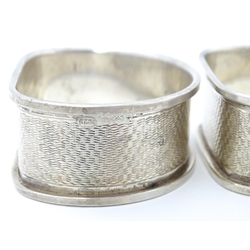 430 - Two silver napkin rings with engine turned decoration. Hallmarked Birmingham 1959/60 maker W I Broad... 