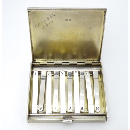 431 - A silver shooting butt / peg marker case with engine turned decoration and opening to reveal a gilde... 