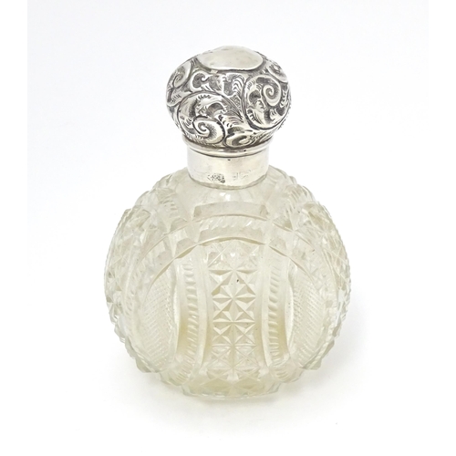 436 - An early 20thC cut glass scent / perfume bottle with silver top . 4