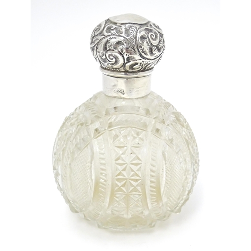 436 - An early 20thC cut glass scent / perfume bottle with silver top . 4