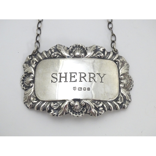 438 - A silver wine / decanter label / bottle ticket for Sherry, hallmarked London 1973. Together with a s... 