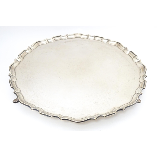 439 - A large silver salver raised on three feet, hallmarked London 1921, maker Hawksworth, Eyre & Co. Ltd... 