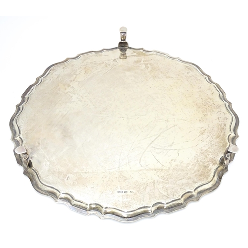 439 - A large silver salver raised on three feet, hallmarked London 1921, maker Hawksworth, Eyre & Co. Ltd... 