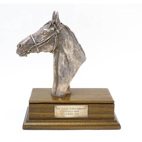 441 - A filled silver horse head trophy, hallmarked Sheffield 1999, maker Camelot Silverware Ltd. on a woo... 