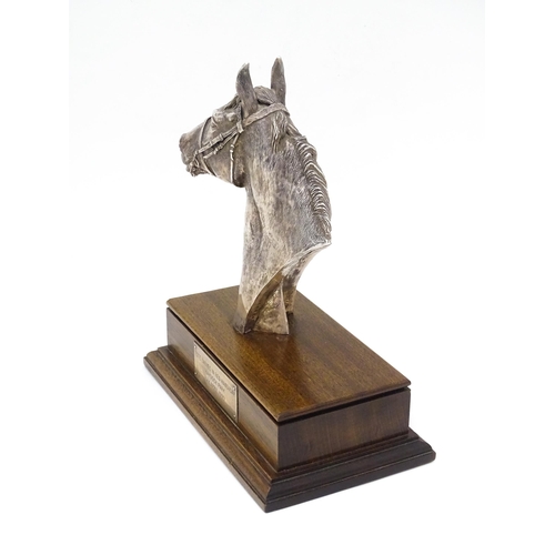 441 - A filled silver horse head trophy, hallmarked Sheffield 1999, maker Camelot Silverware Ltd. on a woo... 