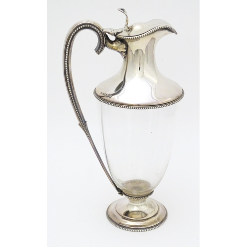 442 - A Victorian glass claret jug with silver mounts and handle, hallmarked Sheffield 1873, maker W. & G.... 