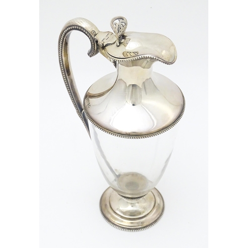 442 - A Victorian glass claret jug with silver mounts and handle, hallmarked Sheffield 1873, maker W. & G.... 