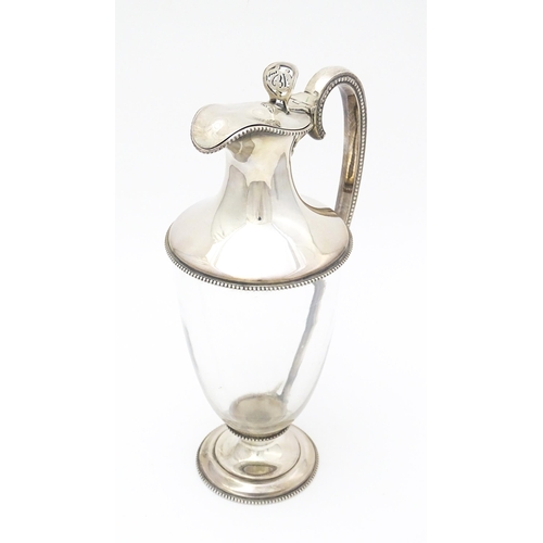 442 - A Victorian glass claret jug with silver mounts and handle, hallmarked Sheffield 1873, maker W. & G.... 