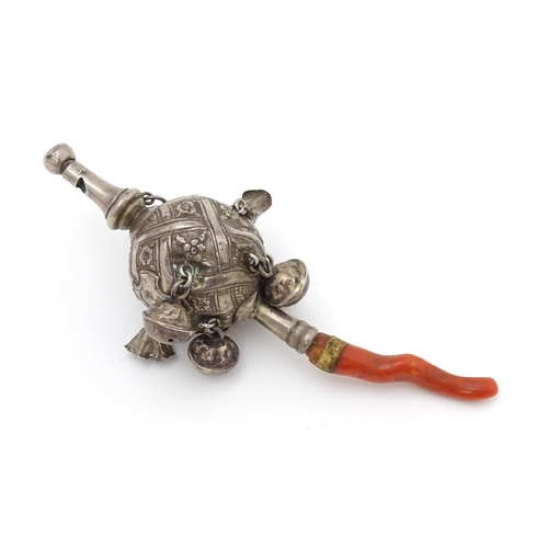 449 - A Continental silver childs rattle with bells, whistle to one end and coral teether to other. Approx... 