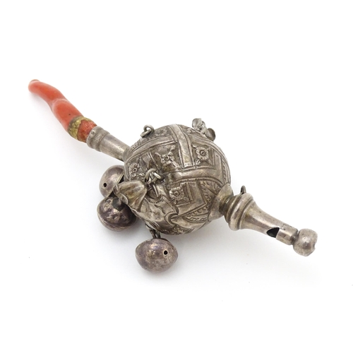 449 - A Continental silver childs rattle with bells, whistle to one end and coral teether to other. Approx... 