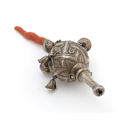 449 - A Continental silver childs rattle with bells, whistle to one end and coral teether to other. Approx... 