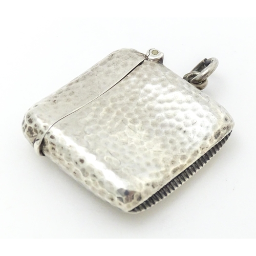 451 - A silver vesta case with hammered decoration hallmarked Birmingham 1906, maker Cornelius Desormeaux ... 