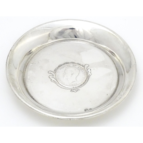 453 - A Portuguese silver dish with inset coin decoration dated 1909. Approx. 4